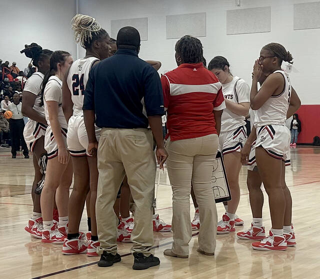 129161765_web1_IMG_1238
Southern Waynes players gather around assistant coach Takisha Vann (red shirt) during a recent game. The Saints had their 26-game regular-season win streak snapped by North Pitt on Wednesday evening. (Rudy Coggins|mountolivetribune.com)