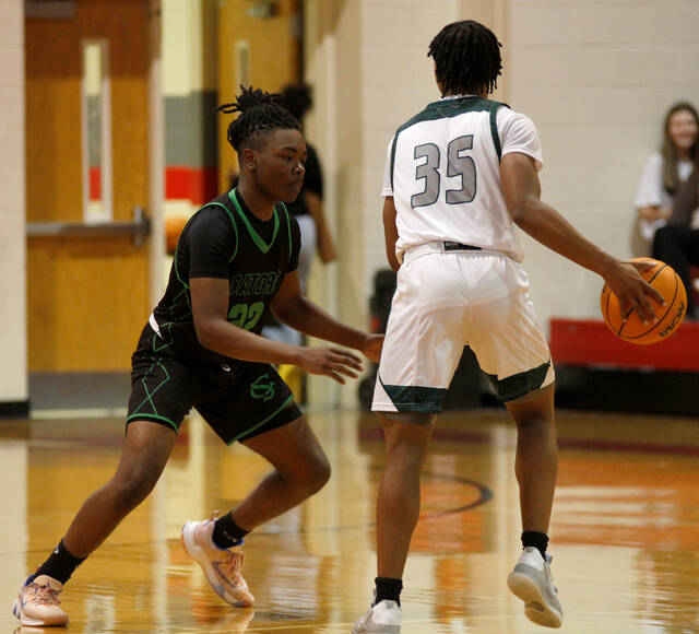 129224754_web1_SC-Boys-B
Spring Creeks Kam McDaniels, left, plays defense against Research Triangle guard Ellis Merriweather during second-half action in the 2022 Johnstonian News Holiday Invitational on Thursday afternoon. McDaniels earned all-tournament honors. (Rudy Coggins|mountolivetribune.com)