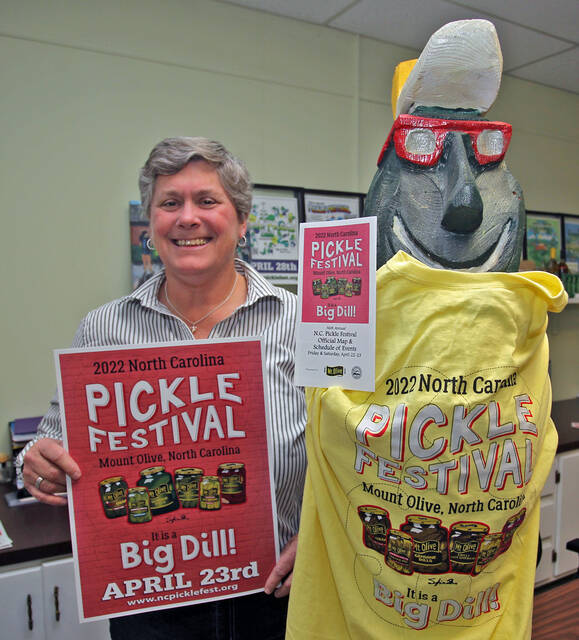 129328377_web1_Pete
N.C. Pickle Festival co-chairman Julie Beck poses with festival mascot Pickle Pete who is wearing one of last years festival T-shirts while holding a copy of the 2022 Pickle Festival brochure that won first place in the medium category during the N.C. Association of Festivals and Events ShowFest Event Innovators Conference held Jan. 29-30 in Charlotte. Beck is holding the 2022 poster that was part of the brochure.