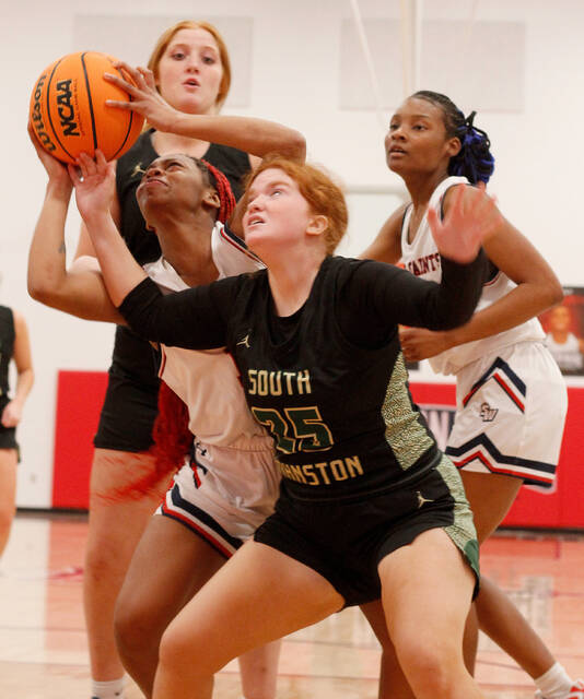 129360080_web1_SaintsGBK2
South Johnston senior Jordyn Brown (35) attempts to knock the ball away from Southern Waynes Elaina Lane during second-half action of their Quad County 3A quarterfinal-round tournament game Monday evening. (Rudy Coggins|mountolivetribune.com)