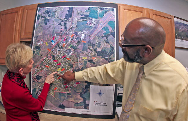 129388912_web1_Planning
Mount Olive town Commissioner Barbara Kornegay and Town Manager Jammie Royall look over a map of downtown Mount Olive Friday, Feb. 17, prior to a Zoom meeting with Liz Parham from the N.C. Dept. of Commerce. The meeting was to discuss downtown planning (Steve Herring|mountolivbetribune.com)