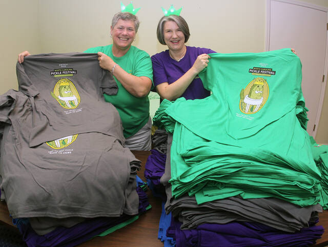 129405899_web1_PF-T-shirts
N.C. Pickle Festival co-chairs Julie Beck, left, and Lynn Williams show off the new festival T-shirts now on sale at the Mount Olive Area Chamber of Commerce, 123 N. Center St. The shirts also will be on sale during the festival (Steve Herring|mountolivetribune.com)