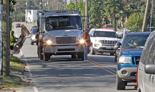 129491389_web1_Trash
A town crew picks up garbage and recycables on a busy South Breazeale Avenue. The town has purchased a new $233,000 truck that will be used for yard waste and debris pickup. It can also pick up and empty trash bins (Steve Herring|mountollivetribune.com)