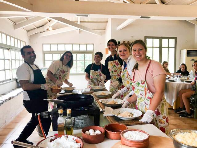 <p>In Delphi, students participated in a Greek cooking class where they served up Tzatziki, zucchini meatballs, and cheese pie.</p>