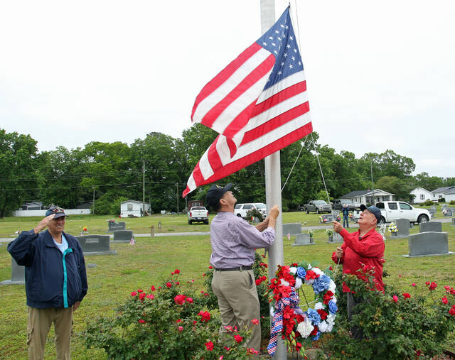129686814_web1_Flag
Mount Olive VFW Post 9959 member J.R. Hudson, left, salutes as Post members Ray Harrell, center, and Hugh Martin, prepare to raise and then lower the flag to half staff Monday morning at Maplewood Cemetery. That portion of the Posts Memorial Day ceremony on Sunday was postponed until noon Monday because of rain. (Steve Herring|mountoloivetribune.com)
