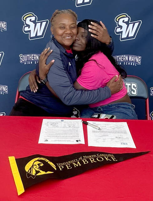 129698688_web1_Ta-NiyahGlaspie
Southern Wayne senior TaNiyah Glaspie, right, gets a hug from track coach Takisha Vann after she signed a national letter of- ntent to run indoor/outdoor track at UNC Pembroke next season. Glaspie was named the Saints Female Athlete of the Year. (Rudy Coggins|mountolivetribune.com)