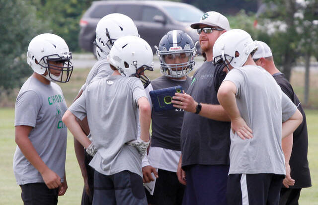 129818627_web1_PIGSKINGatorsPIC13
Daniel Robinson, in hat, shows his Spring Creek football team an offensive play to run during the annual Fellowship of Christian Athletes camp recently held at the University of Mount Olive. Robinson stepped down as the programs head coach Wednesday. (Rudy Coggins|mountolivetribune.com)