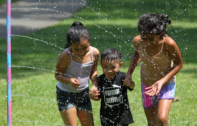 129819279_web1_Splash-7
From left, Hannah Diaz, 7, Angel Bartolon, 4, and Sophia Gomez, 9, hold hands as they race through a sprinkler during Splash Day in the Park on Thursday, July 13, at Westbrook Park. Splash Day, sponsored by Mount Olive Parks and Recreation, is held from 3 to 4 p.m. Tuesdays at Nelson Street Park and from 3 to 4 p.m. Thursdays at Westbrook Park. (Steve Herring|mountolivetribune.com)