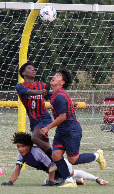 129907321_web1_SaintsBSOC3
Southern Wayne goalie Joey Segura, bottom, gets some defensive help from teammate Skervenson Aphael (9) during second-half action against James Kenan Wednesday afternoon. (Rudy Coggins|mountolivetribune.com)