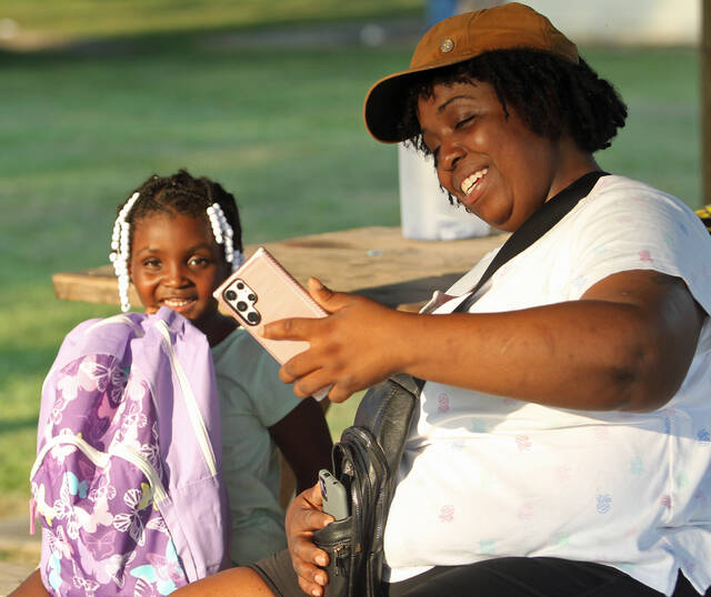 129925898_web1_Selfie
Skylyn Smith, 5, is all smiles as she hugs her new book bag while her mother Keyosha Boykin takes selfies to capture their smiles and the book bag. More than 300 students received new book bags packed with school supplies Saturday, Aug. 19, during the 13th annual Back-to-School Celebration and Free Book Bag Giveaway sponsored by the Men of Faith, Integrity and Character. (Steve Herring|mountolivetribune.com)