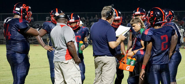 129932199_web1_SaintsTimeout
Southern Wayne head football coach Matt Hine (wearing headset) and offensive coordinator Tori King (gray shirt) talk with the offense during a timeout last week against Eastern Wayne. The Saints claimed their third straight win, 56-14, over Goldsboro on Friday evening. (Rudy Coggins|mountolivetribune.com)