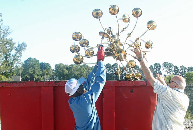 130035499_web1_Recycle-toss
Town employee Ricky McCoy, left, helps Tony Sasser toss a large light fixture into a container at the towns recycling center on Talton Avenue. The centers Saturday hours have been extended. The center now will be open from 8 a.m. to 5 p.m. Monday, Wednesday, Friday and Saturday. It will be closed from noon to 1 p.m. for lunch each day. (Steve Herring|mountolivetribune.com)
