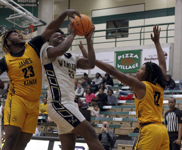 130241278_web1_JKEW5
Eastern Waynes JQ Carr has his shot blocked from behind by James Kenans DeMarion Artis (23) during second-half action Wednesday evening. Defending the play is Artis teammate, Hassan Kornegay. (Rudy Coggins|mountolivetribune.com)