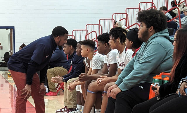 130326134_web1_BrianWest
Southern Wayne head coach Brian West, left, talks with Jayden Hardy and his teammates on the bench during a recent game. Hardy scored 25 points in the Saints road win at South Johnston Tuesday evening. (Rudy Coggins|mountolivetribune.com)