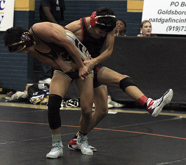 130326141_web1_OmarNECP
Southern Wayne sophomore Omar Soler-Sanchez, back, attempts to sweep the outer leg and take North East Carolina Preps Alan Tebalan to the mat during their 113-pound match Wednesday evening. Soler-Sanchez pinned Tebalan. (Rudy Coggins|mountolivetribune.com)