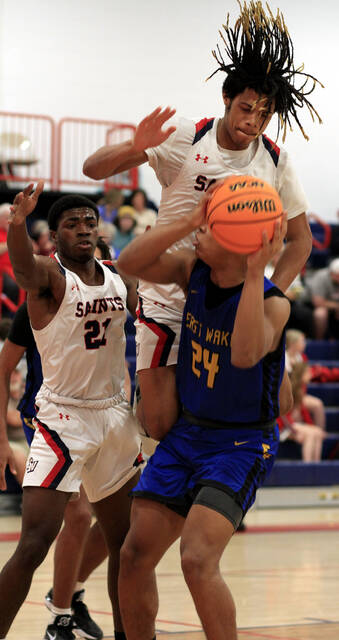 130331803_web1_SaintsBKBg
Southern Waynes Jayden Hardy blocks a shot by East Wakes Malachi Harris during their Quad County 3A game Friday evening. Watching is teammate Jaylen Bowden. (Rudy Coggins|mountolivetribune.com)