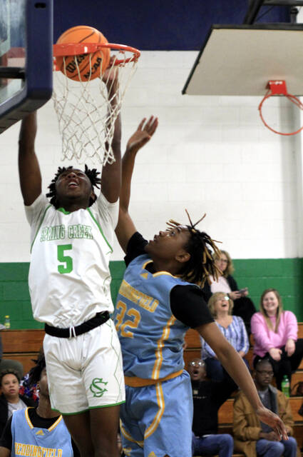 130341605_web1_SCB1
Spring Creeks Brennan Chambers (5) dunks over Beddingfields Darrian Jones during first-quarter play Tuesday evening in The Swamp. (Rudy Coggins|mountolivetribune.com)