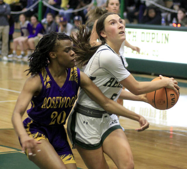 130388313_web1_BasketballPairings
North Duplin junior point guard Addy Higginbotham, right, and her teammates seek to three-peat as the Carolina 1A tournament champions this week. The Rebels will host the semifinals and finals. (Rudy Coggins|mountolivetribune.com)