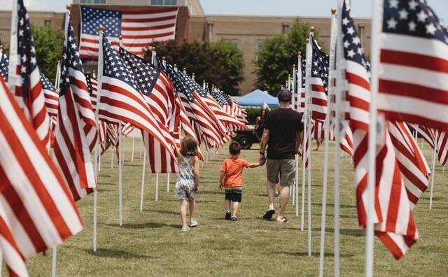 130392941_web1_field-of-heroes-1
The Exchange Club of Mount Olive is holding its inaugural Field of Heroes event May 17-27. Anyone can participate by purchasing a flag, in honor or memory of a hero, from the Exchange Club; plus there are sponsorship opportunites for businesses. Members of the public will be welcome to walk through and enjoy the display, similar to what is happening in the photo, showing a previous years Field of Heroes event in Lake Norman. (The Exchange Club of Lake Norman|Courtesy photo)