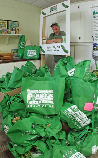 130556471_web1_PF-bag
N.C. Pickle Festival co-chair Julie Beck is surrounded by piles of the Very Important Pickle totes full of pickle-related items that will be sold Saturday, April 27, during the 38th annual N.C. Pickle Festival. There is no admission to the award-winning festival that will feature 175 vendors, a car show, four stages of free entertainment and avariety of events and activities including a pickle-eating contest. (Steve Herring|mountolivetribune.com)
