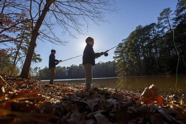 130635515_web1_ncwrc-2023-12-20-Trout-Fishing-01-Red
Trae Hartley, left, fishes with his six-year-old son Finn Hartley, center, at Simpkins Pond in Wake County after the North Carolina Wildlife Resources Commission stocked the water with trout Wednesday afternoon Dec. 20, 2023.