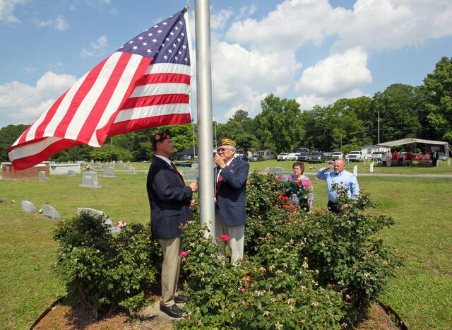 130643413_web1_MD-Flag
Mount Olive VFW Post 9959 interim Commander James Benson, left, salutes and Post Auxiliary President Violet Saviak places her hand over her heart as Post members Ray Harrell, left, and Ronald Hatch lower the U.S. flag to half-staff Sunday during the annual Memorial Day observance in Oakview Cemetery (also known as Maplewood Cemetery). (Steve Herring|mountolivetribune.com)