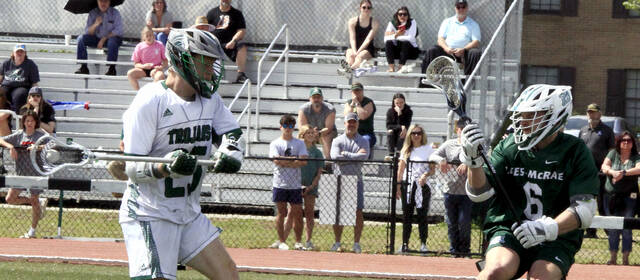 130752120_web1_Joby-Hawn-Cup-pic
University of Mount Olive attackman Joshua Dewart, left, fires a shot on goal against a Lees-McRae defender during a Conference Carolinas game last spring. Dewart helped the Trojans claim the tournament title for the first time in program history.