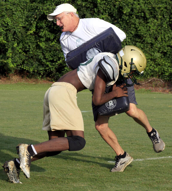130804672_web1_NDHugh
North Duplin head football coach Hugh Martin, back, takes a hit from Marcus Hill during a trap blocking skill during practice Friday morning in Calypso. (Rudy Coggins|mountolivetribune.com)