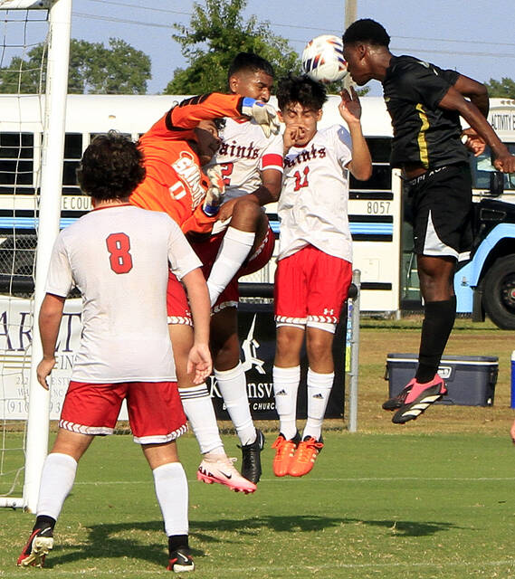 130864440_web1_JKSWsoccer
Southern Wayne goalie Jefferson Morales (orange shirt) attempts to save a header by James Kenans Kebert Davis on a first-half corner kick. Defending with Morales are Cole Lane (8), Alex Trejo (2) and Angel Ramirez (11). Morales had 12 saves in the Saints road loss. (Rudy Coggins|mountolivetribune.com)