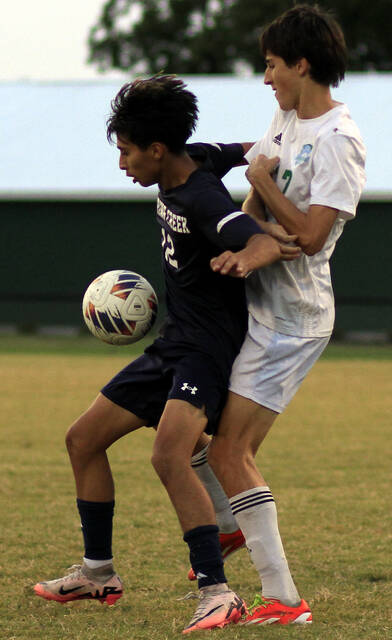 130899153_web1_SCRoseBSOC
Spring Creeks Gustabo Vargas Fajardo, left, keeps the ball away from J.H. Rose defender Jackson McCarren during second-half action Monday evening. (Rudy Coggins|mountolivetribune.com)