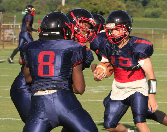 130983098_web1_SaintsLogan
Southern Wayne quarterback Logan Denning (with ball) gets in some pre-game work earlier this season. The signal caller threw for a career-high 121 yards in a loss against South Johnston on Friday evening. (Rudy Coggins|mountolivetribune.com)