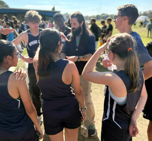 131020721_web1_SpringCreekCrossCountry
Fourth-year Spring Creek head coach Ian Combest, background, talks with his runners during the NC High School Athletic Association Class 2A east regional Saturday at Lenoir County Fairgrounds in Kinston. (Contributed photo)