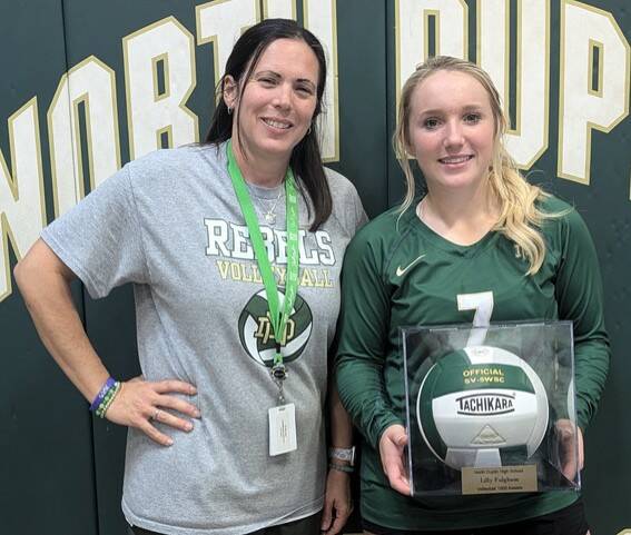 131050101_web1_NDLilly1000
North Duplin junior setter Lilly Fulghum, right, surpassed 1,000 assists for her volleyball career in a home match against Hobbton. Standing with Fulghum is Rebels head coach Heather Best. (Rudy Coggins|mountolivetribune.com)