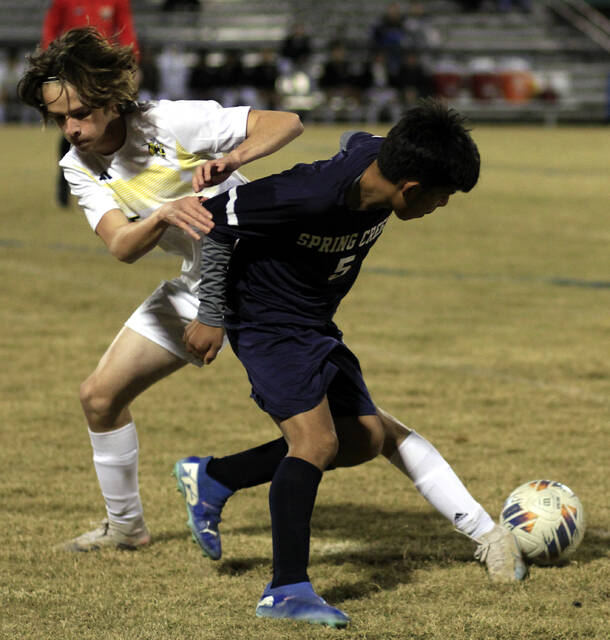 131057078_web1_SCRoRapBSOC
A Spring Creek player battles with Roanoke Rapids Jeremy Robertson, back, for possession of the ball during their playoff game Saturday evening in The Swamp. (Rudy Coggins|mountolivetribune.com)