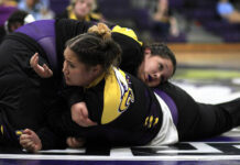 
			
				                                Rosewood senior Sophia Marshall, front, warms up with her sister, AJ, before a dual-team match this season. Sophia signed an NLI to wrestle next season at the University of Mount Olive. (Rudy Coggins|mountolivetribune.com)
 
			
		