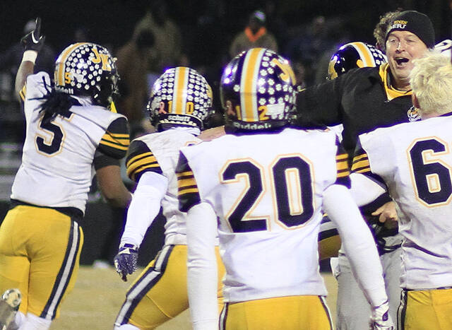 131106793_web1_TigersWRH1
James Kenan defensive coordinator John Bert Avent, far right, celebrates with players after upsetting Wallace-Rose Hill, 14-13 in overtime Friday evening. (Rudy Coggins|mountolivetribune.com)