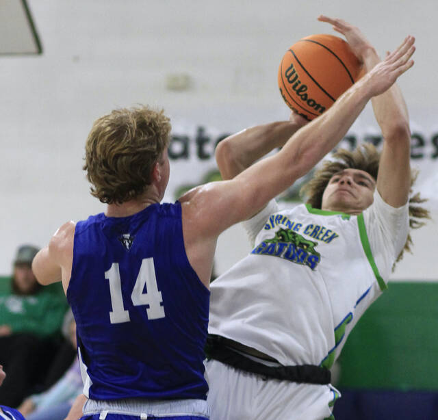 131132047_web1_SMBoys3
Spring Creeks Nathan Jackson gets fouled by Midways Wyatt Herring on a second-half baseline shot Monday evening. (Rudy Coggins|mountolivetribune.com)