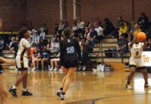 
			
				                                Lady Tiger Shamya Johnson, with foes on her heels, makes a three-point attempt during a game against South Lenior. (Robert Taylor|mountolivetribune.com)
 
			
		