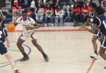 
			
				                                Southern Wayne’s Jaylen Carr, #20, tries to find a hold through a group of Spartan defenders. (Robert Taylor|mountolivetribune.com)
 
			
		