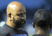 
			
				                                Dr. Ronald Wise talks with another coach on the sidelines during a previous football game before he took over the Gators’ program.
                                 File photo

			
		