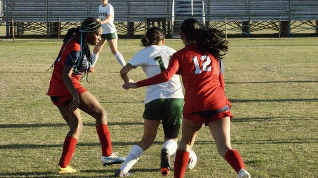 131387620_web1_SWsoccer-3
No. 7 Mohaganee Miller and Nop. 12 Rosilinda Quiroz double team the offense attempting to take possession of the ball. (Robert Taylor|mountolivetribune.com)