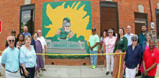 
			
				                                Mount Olive’s newest mural was unveiled during a brief Tuesday afternoon ceremony. Left to right are, Judson Pope, Pope Transport; Al and Deborah Southerland, Men of FIC, Rotary; Pam Brewer, building owner; Dave Sauls, Southern Bank; Lauren Saegar, Steele Memorial Library; Steve Wiggins, Mount Olive Community Development Corp. president; artist Winford Galmon; Jennifer Ricks Merritt, University of Mount Olive; Julie Beck, Mount Olive Area Chamber of Commerce president; Anna Hinson, Arts Council of Wayne County executive director; Bill Bryan, Mt. Olive Pickle Co.; Barbara Kornegay, Development Corp.; Ed Olive, UMO Agribusiness Center; Lynn Williams, N.C. Pickle Festival co-chair; and Mayor Jerome Newton. (Steve Herring|mountolivetribune.com)
 
			
		