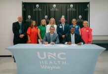 
			
				                                Seated are UMO President Dr. H. Edward Croom and UNC Health Wayne President and CEO Dr. Jessie Tucker. Standing are representatives from both UMO and UNC Health Wayne. (UMO Photo)
 
			
		