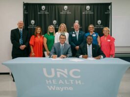 
			
				                                Seated are UMO President Dr. H. Edward Croom and UNC Health Wayne President and CEO Dr. Jessie Tucker. Standing are representatives from both UMO and UNC Health Wayne. (UMO Photo)
 
			
		