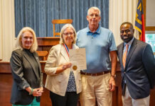
			
				                                Becky and Chip Craig (center) with North Carolina Commission on Volunteerism and Community Service Volunteerism Coordinator Kenneth McLellan (right) and Executive Director S. Briles Johnson at the ceremony honoring the 2025 Governor’s Medallion Award for Volunteer Service recipients.
 
			
		