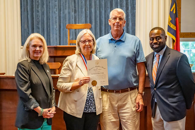 131561351_web1_Becky-and-Chip-Medallion-Ceremony
Becky and Chip Craig (center) with North Carolina Commission on Volunteerism and Community Service Volunteerism Coordinator Kenneth McLellan (right) and Executive Director S. Briles Johnson at the ceremony honoring the 2025 Governors Medallion Award for Volunteer Service recipients.
