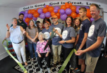 
			
				                                Brad Mitchell and Jennifer Bland use a large pair of ceremonial scissors Friday afternoon for the ribbon-cutting ceremony for the Mount Olive location of their Grounded and Baked bakery and coffee shop. The bakery features baked goods using the recipes Mitchell’s grandmother, Norma Ann “Nanny” Vinson, seated, taught him. From left are, Mount Olive Area Chamber of Commerce President Julie Beck; Chamber board Chairman Edward Olive; Mitchell’s wife, Wendy; Mount Olive town Commissioner Vicky Darden; Mitchell’s aunt, Debbie Hardy; Norma Ann “Nanny” Vinson; Mitchell’s mother, Dianne Mitchell; Chamber Ambassador Pernell Brickey; Mitchell; Bland and her daughter, Collins; son, Andrew; and husband Frank. The business is located in the old Henderson-Crumpler Clinic, 229 N. Center St. (Steve Herring|mountolivetribune.com)
 
			
		
