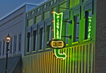 
			
				                                Glowing bright green and yellow, the neon sign at the Mt. Olive Pickle Co. Pickle Parlor has changed the appearance of downtown and is particularly noticeable at night. (Steve Herring|mountolivetribune.com)
 
			
		