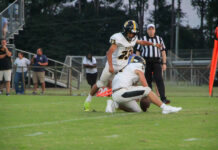 
			
				                                James Kenan’s I. Covarruibus kicks the PAT following a touchdown drive in Friday’s game against the Saints.
 
			
		