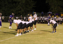 
			
				                                James Kenan’s quarterback No. 11 Eli Avent lining up the offense for a drive. (Kareem Brown photo)
 
			
		